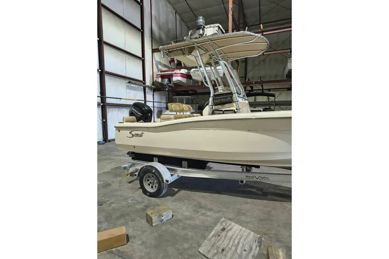 Slide: The Image of 2020 Scout 195 Sportfish boat on trailer in warehouse setting. - 7