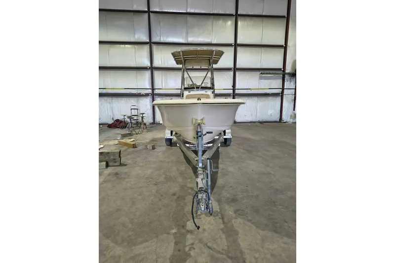 Slide: The Image of 2020 Scout 195 Sportfish boat on trailer in a warehouse setting. - 8