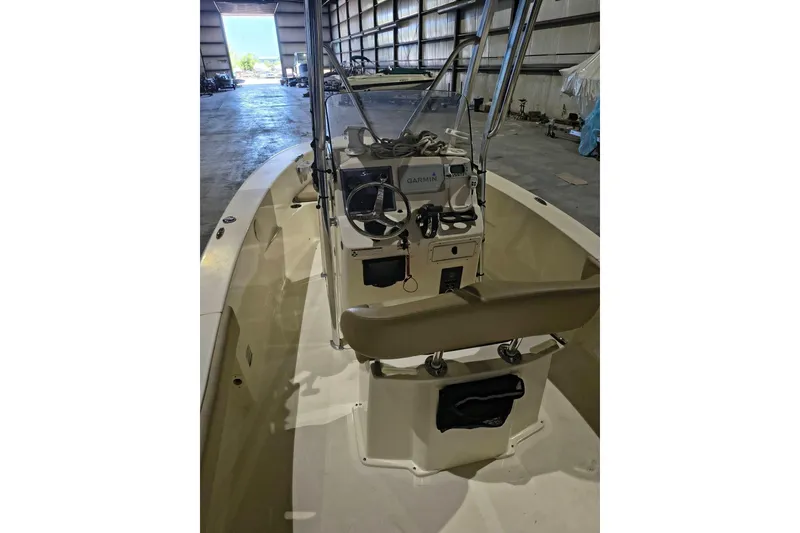 Slide: The Image of 2020 Scout 195 Sportfish boat interior with Garmin equipment in a warehouse. - 9