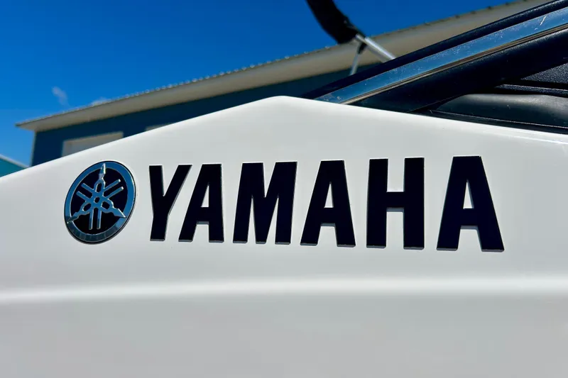 Slide: The Image of Close-up of 2024 Yamaha SX195 boat logo against a clear blue sky. - 12
