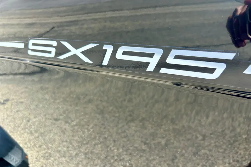 Slide: The Image of 2024 Yamaha Boats SX195 logo on sleek boat surface. - 13