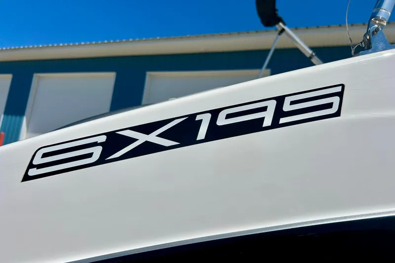 Slide: The Image of 2024 Yamaha Boats SX195 logo on white boat exterior under clear blue sky. - 14
