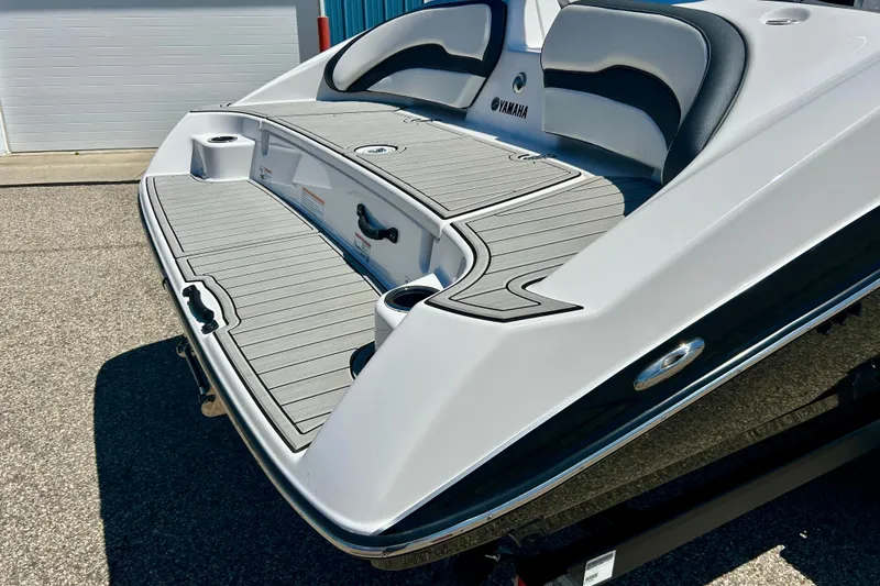 Slide: The Image of 2024 Yamaha Boats SX195 rear deck with sleek design and comfortable seating. - 15