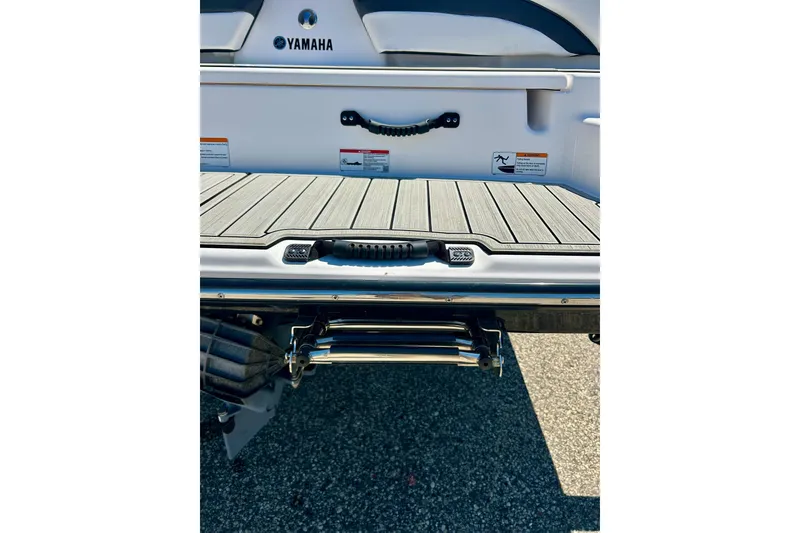 Slide: The Image of 2024 Yamaha Boats SX195 swim platform with ladder and safety features. - 17