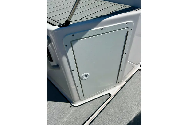 Slide: The Image of 2024 Yamaha Boats SX195 storage compartment with sleek design and secure latch. - 21