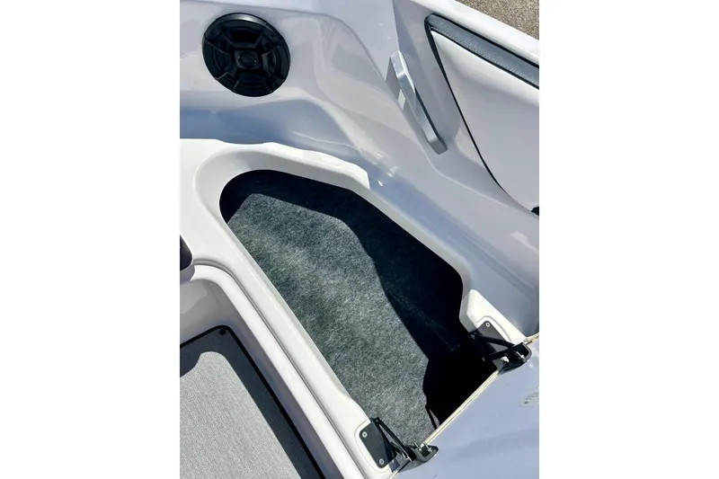 Slide: The Image of 2024 Yamaha SX195 boat interior storage compartment with speaker and handle. - 27