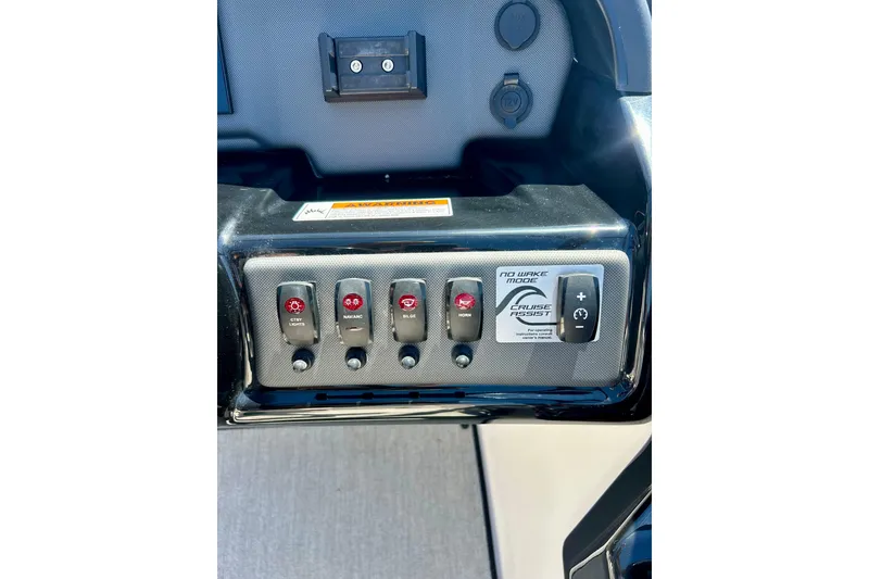 Slide: The Image of Control panel of 2024 Yamaha Boats SX195 featuring various switches and cruise assist. - 39