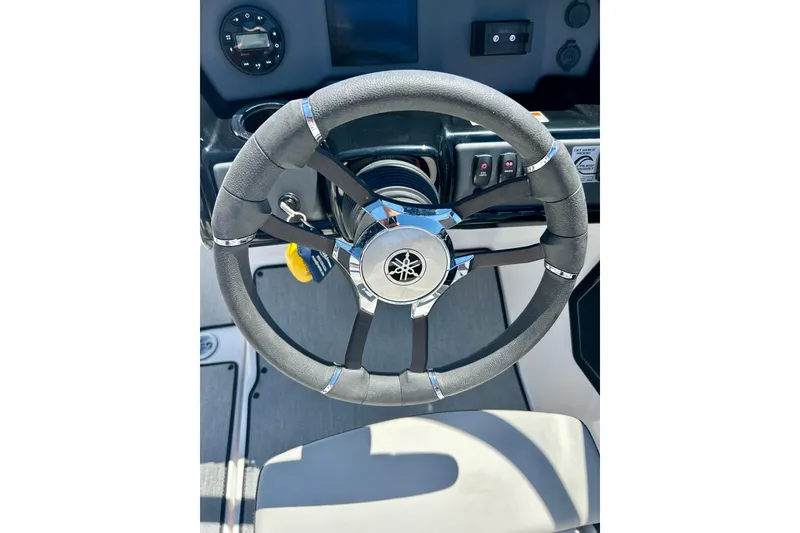Slide: The Image of 2024 Yamaha Boats SX195 steering wheel and dashboard, featuring sleek design and modern controls. - 40