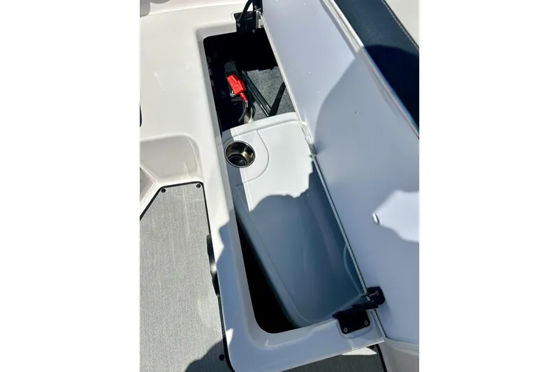 Slide: The Image of 2024 Yamaha Boats SX195 storage compartment with cup holder, open for viewing. - 46