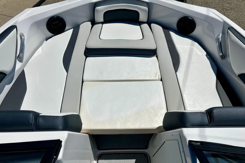 Slide: The Image of 2024 Yamaha Boats SX195 interior seating with sleek white and gray upholstery. - 49