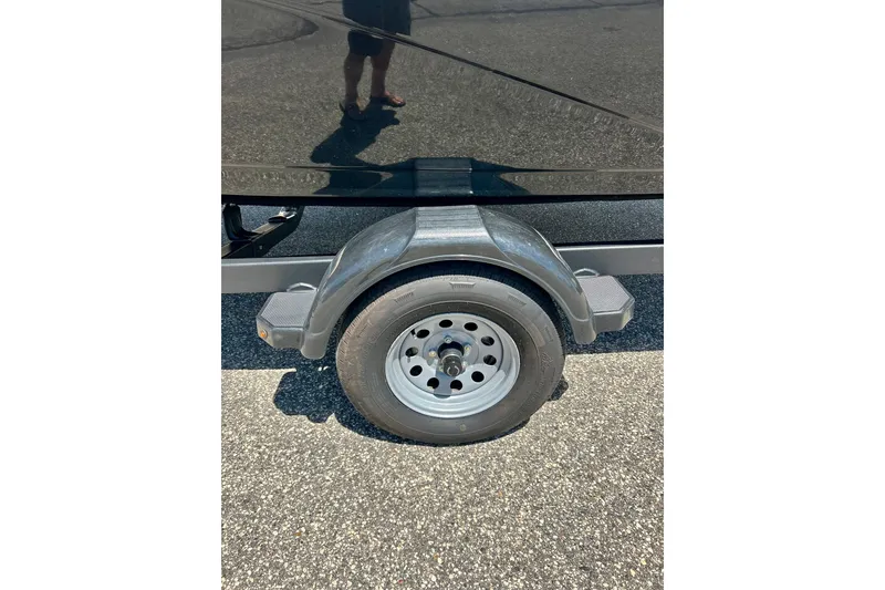 Slide: The Image of 2024 Yamaha Boats SX195 trailer wheel on asphalt surface. - 57
