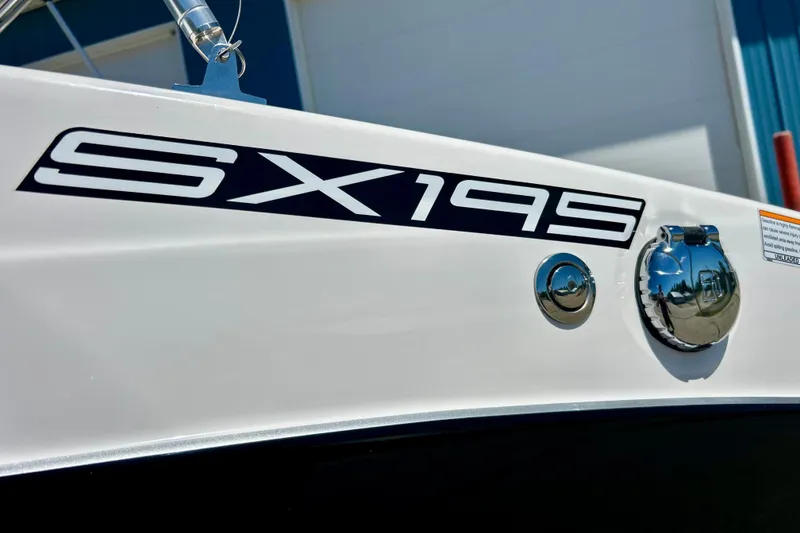 Slide: The Image of 2024 Yamaha Boats SX195 model nameplate on sleek white hull. - 59