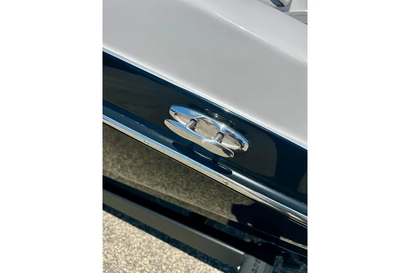 Slide: The Image of 2024 Yamaha Boats SX195, close-up of sleek chrome cleat on glossy hull. - 61