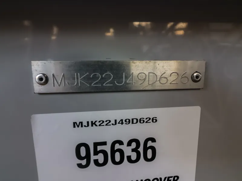 Slide: The Image of Close-up of a metal plaque engraved with "MJK22J49D626" on a boat. - 24