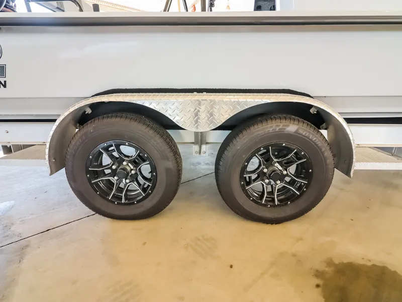 Slide: The Image of Close-up of two black wheels on a boat trailer with silver rims. - 21