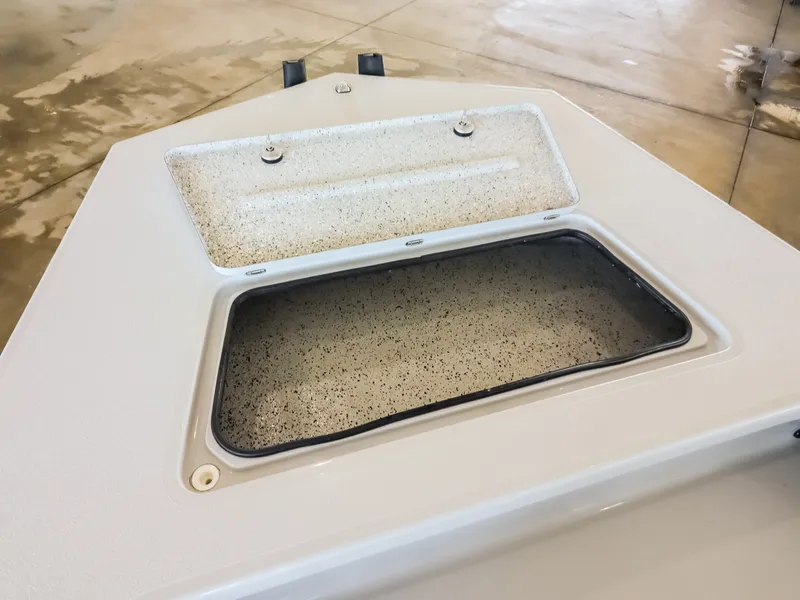 Slide: The Image of An open storage compartment on a 2026 Majek M2 Illusion boat, set on a concrete floor. - 19