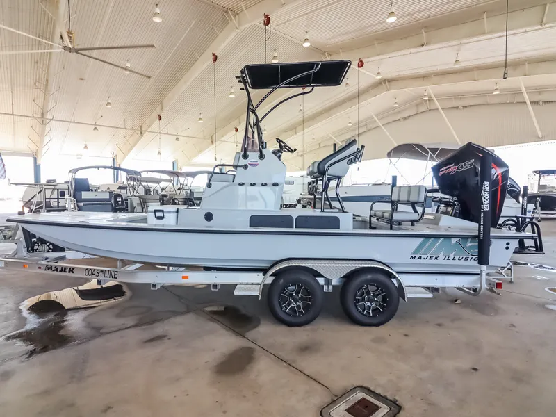 Slide: The Image of A 2026 Majek M2 Illusion boat on a trailer in a covered storage facility. - 2