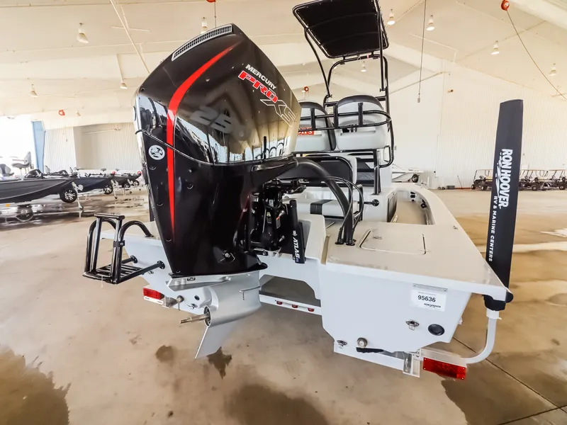 Slide: The Image of The image shows a 2026 Majek M2 Illusion boat in a warehouse. It features a large outboard motor. - 23