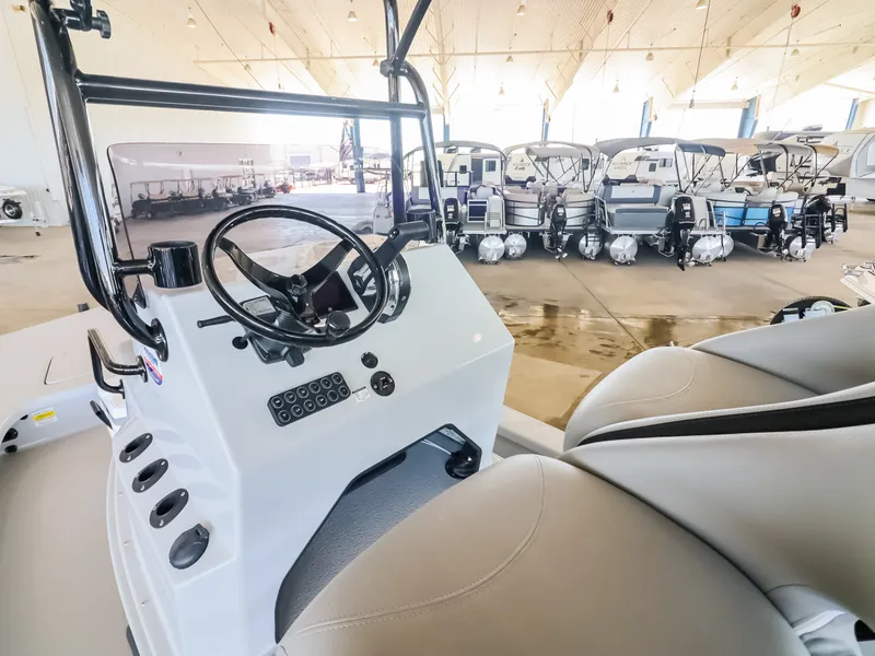 Slide: The Image of The image shows the cockpit of a Majek M2 Illusion boat in a showroom. - 13