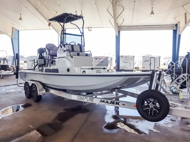 Slide: The Image of A 2026 Majek M2 Illusion boat on a trailer in a covered storage area. - 3