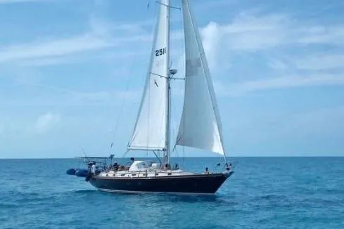The Image of 1986 Little Harbor LH46 sailboat cruising on open blue sea under clear skies. - 1