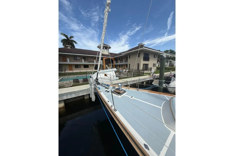 Slide: The Image of 1986 Little Harbor LH46 yacht docked near waterfront buildings under a clear sky. - 10