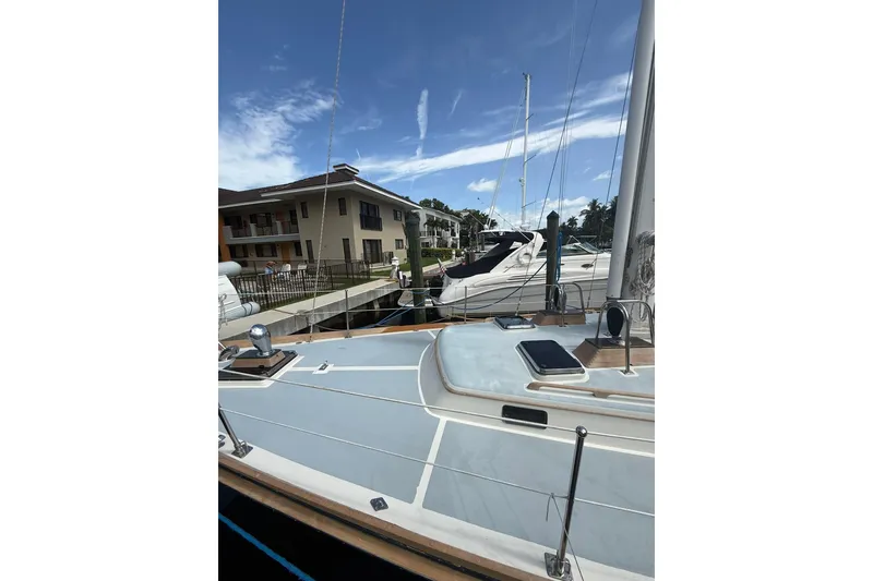 Slide: The Image of 1986 Little Harbor LH46 yacht docked at marina under clear blue sky. - 11