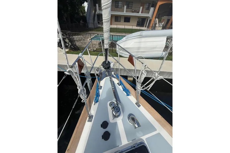 Slide: The Image of Bow view of 1986 Little Harbor LH46 sailboat docked near a building. - 14
