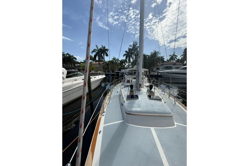 Slide: The Image of 1986 Little Harbor LH46 sailboat deck view with clear sky and palm trees. - 17
