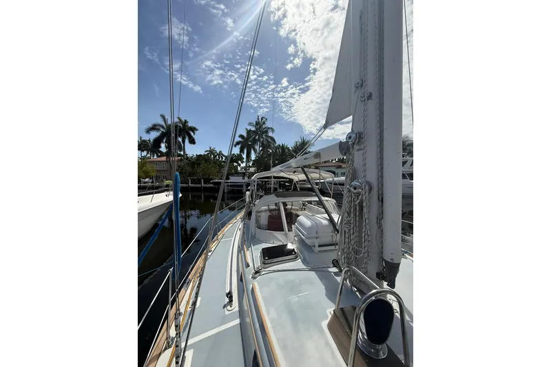Slide: The Image of 1986 Little Harbor LH46 sailboat docked under a sunny sky with palm trees. - 19