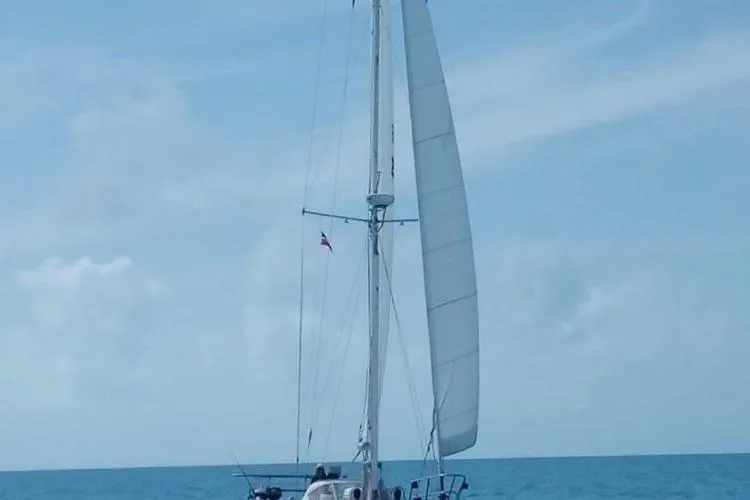 Slide: The Image of 1986 Little Harbor LH46 sailboat cruising on open sea under clear skies. - 2