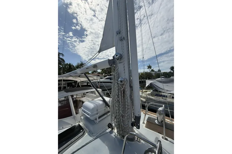 Slide: The Image of 1986 Little Harbor LH46 sailboat deck with mast and rigging under a partly cloudy sky. - 20