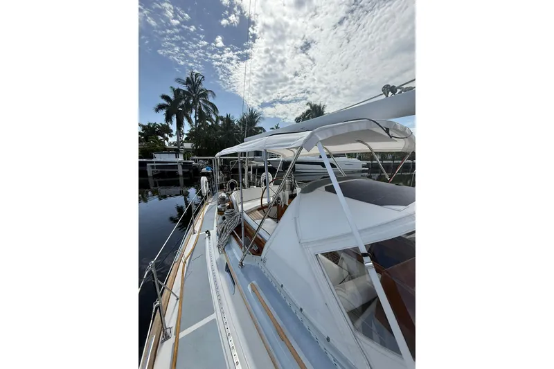 Slide: The Image of 1986 Little Harbor LH46 yacht docked, featuring sleek design and tropical surroundings. - 22
