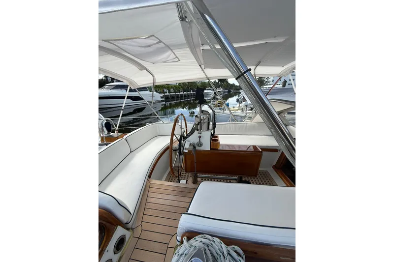 Slide: The Image of Cockpit of 1986 Little Harbor LH46 yacht with white seating and wooden accents. - 23