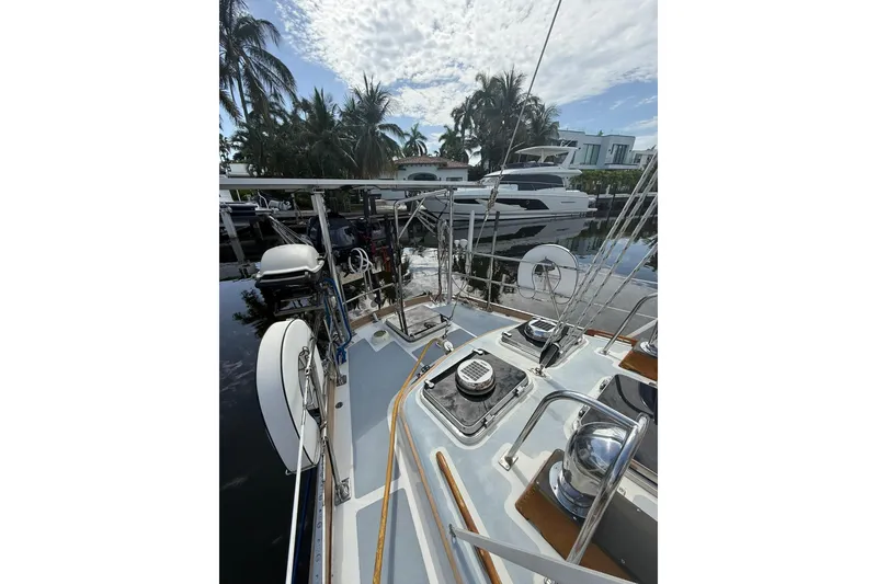 Slide: The Image of 1986 Little Harbor LH46 yacht deck with marina view, palm trees, and luxury boats. - 25