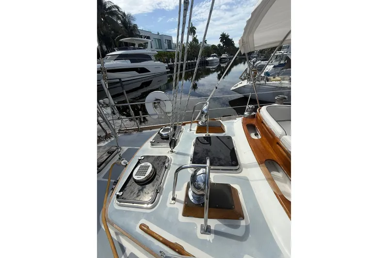 Slide: The Image of 1986 Little Harbor LH46 yacht deck with winches and hatches, docked near other boats. - 26