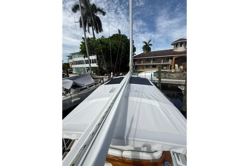 Slide: The Image of 1986 Little Harbor LH46 sailboat docked near palm trees and buildings. - 30