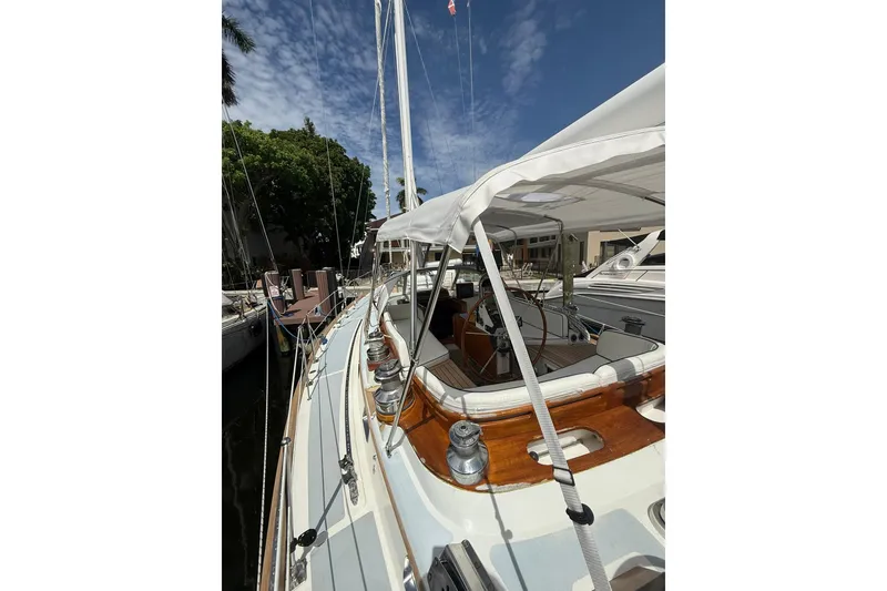 Slide: The Image of 1986 Little Harbor LH46 sailboat docked, showcasing deck and cockpit under sunny skies. - 33