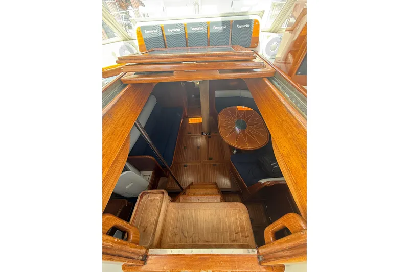 Slide: The Image of Interior view of 1986 Little Harbor LH46 yacht, showcasing wooden finishes and seating area. - 41