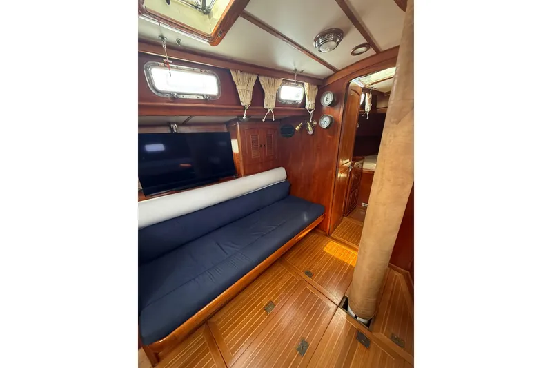 Slide: The Image of Interior of 1986 Little Harbor LH46 yacht with wooden finish and blue seating. - 46