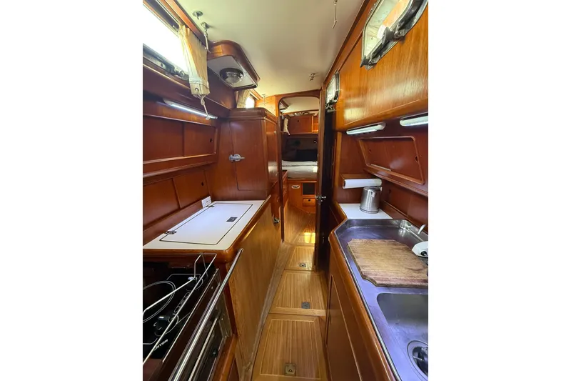 Slide: The Image of Interior of 1986 Little Harbor LH46 yacht with wooden cabinetry and compact kitchen area. - 51