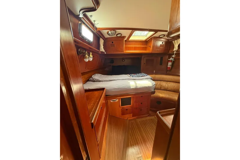 Slide: The Image of Cozy cabin interior of 1986 Little Harbor LH46 yacht with wooden furnishings and bed. - 53