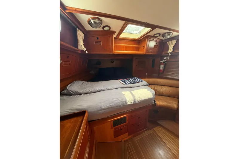 Slide: The Image of Cozy cabin interior of 1986 Little Harbor LH46 yacht with wooden furnishings and skylight. - 54