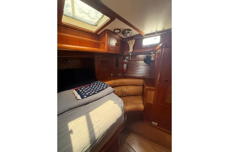 Slide: The Image of Cozy cabin interior of 1986 Little Harbor LH46 yacht with wooden finishes and natural light. - 55