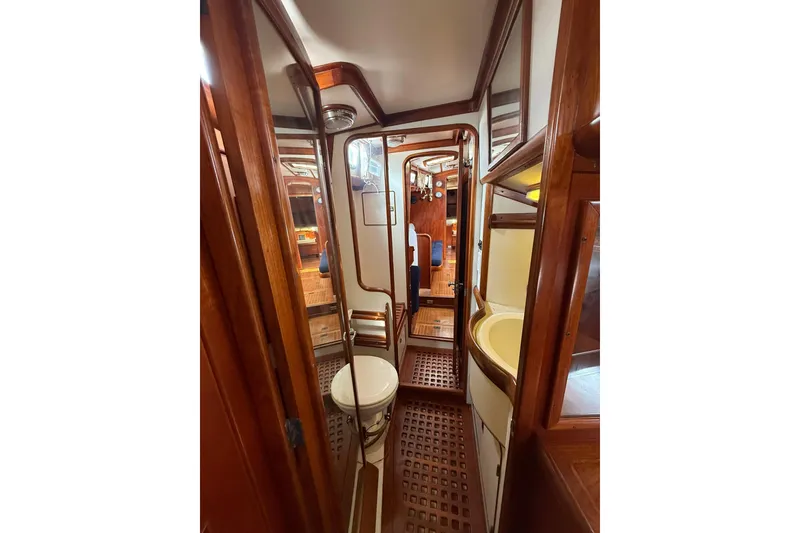 Slide: The Image of Interior of 1986 Little Harbor LH46 yacht, featuring wooden finishes and compact bathroom. - 57