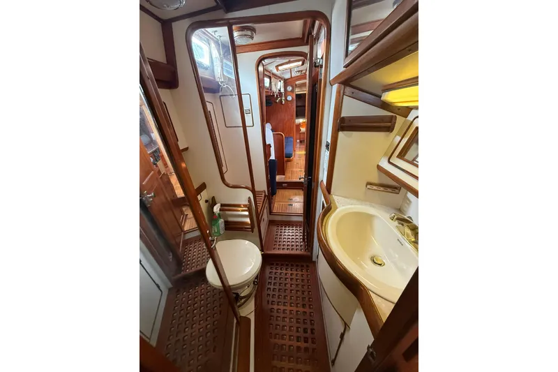 Slide: The Image of Interior of 1986 Little Harbor LH46 yacht, featuring wooden finishes and compact bathroom. - 58