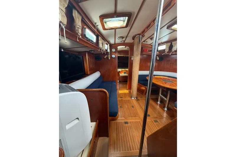 Slide: The Image of Interior of 1986 Little Harbor LH46 yacht with wooden furnishings and blue seating. - 63