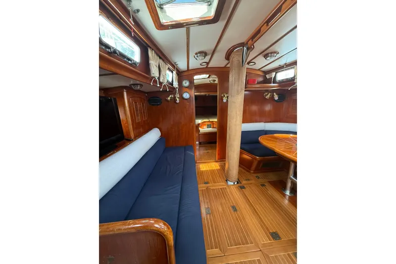 Slide: The Image of Interior of 1986 Little Harbor LH46 yacht with wooden finishes and blue seating. - 65