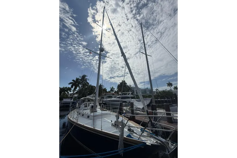 Slide: The Image of Sailboat Little Harbor LH46, 1986 model, docked under a partly cloudy sky. - 7