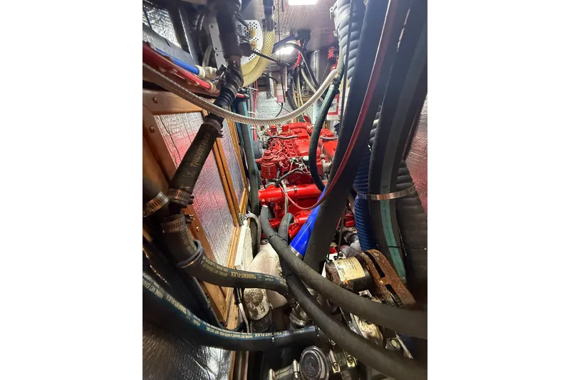 Slide: The Image of Engine room of a 1986 Little Harbor LH46 yacht with visible hoses and machinery. - 75